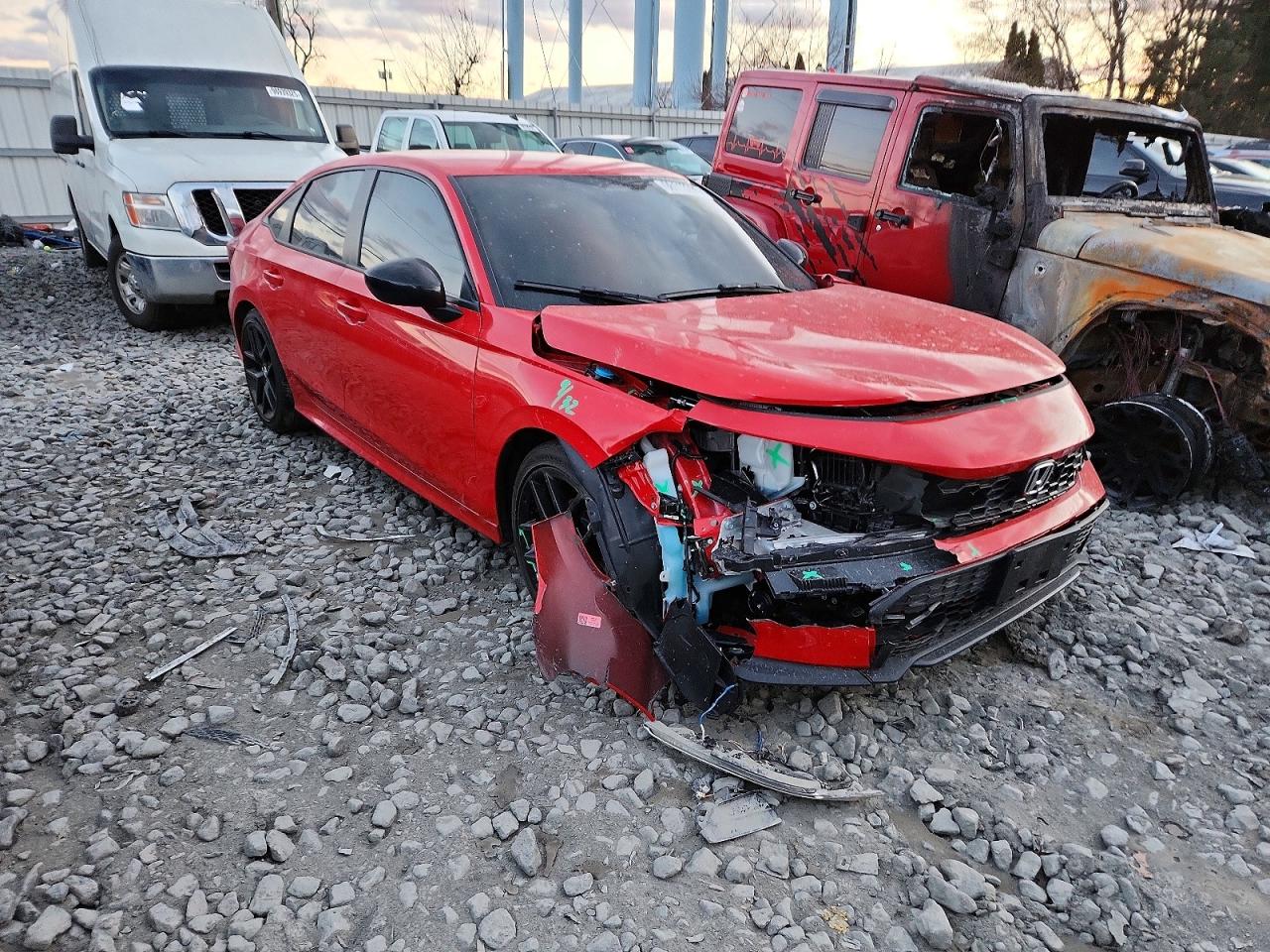 Red 2025 Honda Civic Sport front-left corner impact damage at auction yard